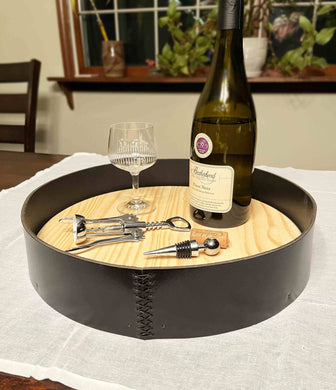 Leather serving tray, 15-inch raw wood on a dining table.