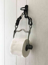 Load image into Gallery viewer, Equestrian bit toilet roll holder with leather and steel curb chain, suspended from a black farm bucket hook