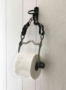 Equestrian bit toilet roll holder with leather and steel curb chain, suspended from a black farm bucket hook