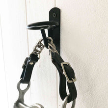 Load image into Gallery viewer, Equestrian Bit Toilet Roll Holder / Tea Towel Hanger, reclaimed curb bit with leather and steel chain, black farm bucket hook, equestrian-themed decor.