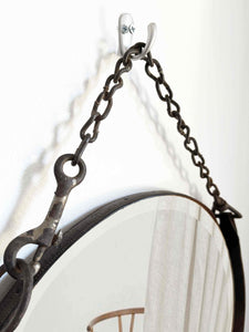 16" round mirror with hand-tacked leather frame and weathered farm chain hanger.