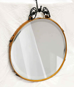 24" black and tan leather circle mirror with antique iron bit