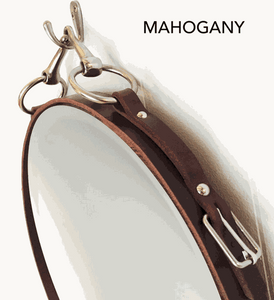 Mahogany leather equestrian oval mirror with genuine nickel-finish details, featuring a snaffle bit faux-hanger.