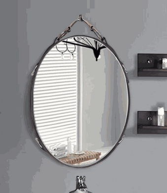 Vertical oval leather equestrian mirror with snaffle bit accents, perfect for horse decor enthusiasts.