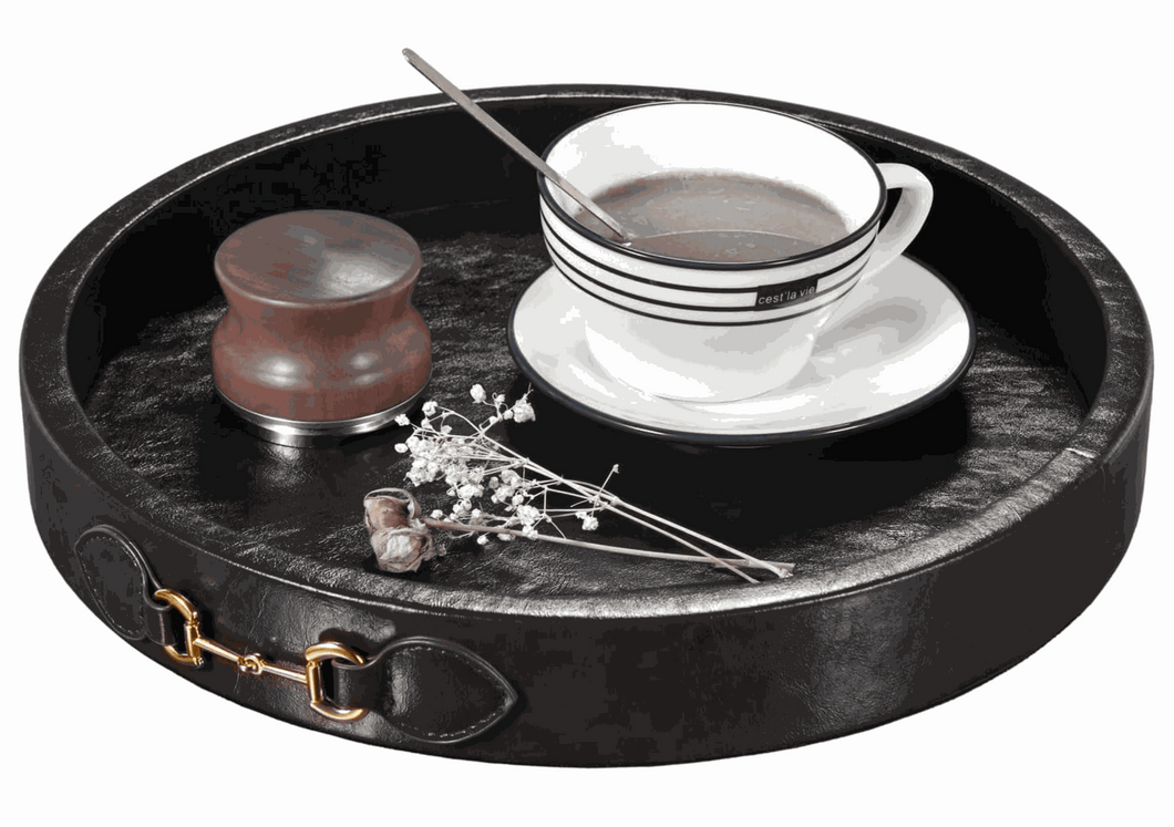 Vegan leather equestrian serving tray with brass snaffle bit handles, featuring a cup and decor objects.