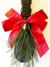 Load image into Gallery viewer, Rustic equestrian leather ornament door greeter with red bow and bronze jingle bell for holiday decor.