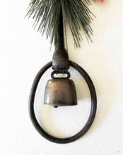 Load image into Gallery viewer, Holiday decor rustic iron equestrian bit door greeter with evergreen, red satin bow, and bronze mini cow bell.