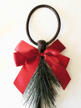 Load image into Gallery viewer, Holiday rustic iron equestrian bit door greeter with red bow and evergreen sprig.