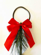 Load image into Gallery viewer, Holiday rustic iron equestrian bit door greeter with red bow and evergreen sprig.