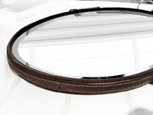 Load image into Gallery viewer, Oval leather mirror with waxed bridle frame and nickel snaffle bit hanging, measuring 12&quot;x16&quot;.