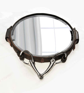 Oval equestrian leather mirror with snaffle bit, handcrafted horse harness decor.