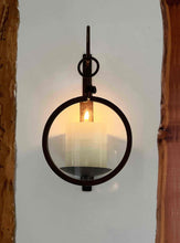 Load image into Gallery viewer, Erica Jacobson magnifying glass wall candle sconces with antique-style design and ivory pillar candle.